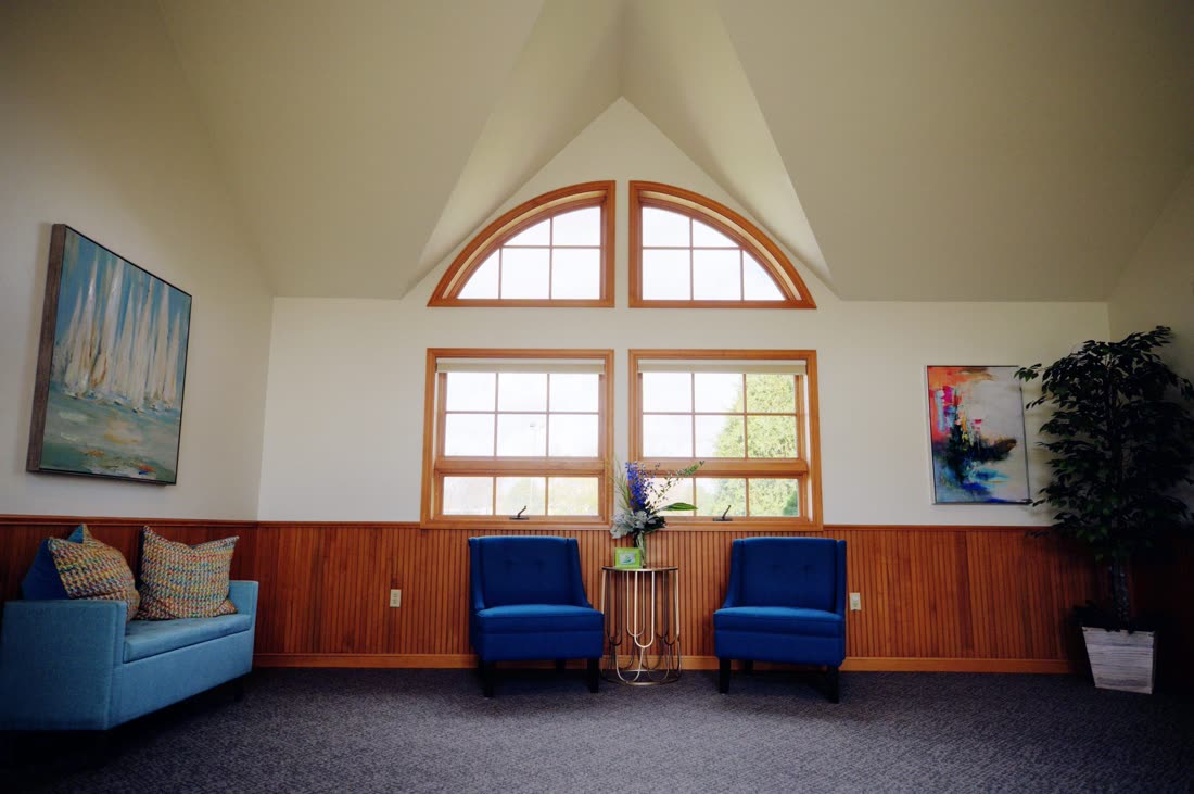 Waiting area with vaulted ceiling and arched windows at Cranston Family Dentistry